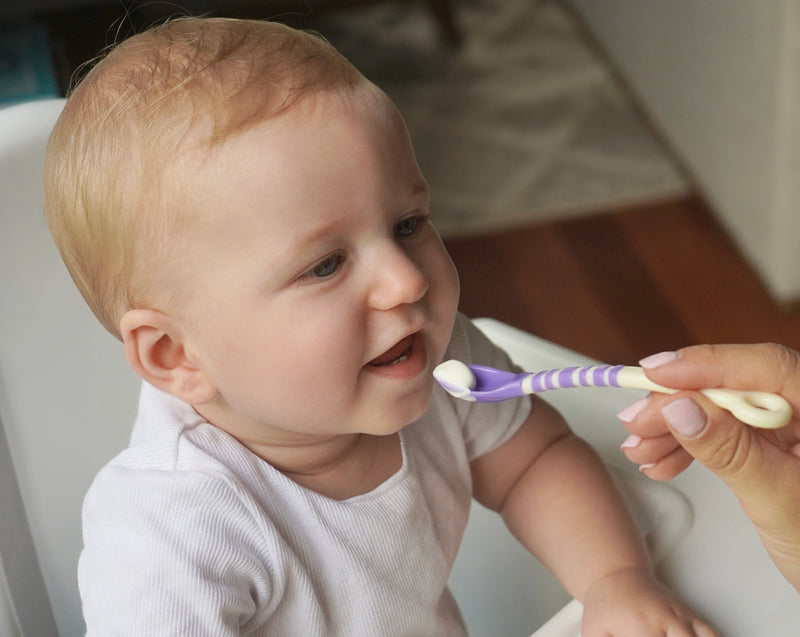 Baby being fed by mother, First Feeding Spoons, purple spoon